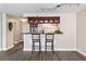 Kitchen bar area with wood cabinets, pendant lighting, and seating for two at 620 Peachtree Ne St # 911, Atlanta, GA 30308