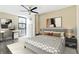 Comfortable bedroom with a ceiling fan, workstation, neutral walls, and a bright window at 620 Peachtree Ne St # 911, Atlanta, GA 30308