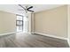 Open bedroom with hard surface floors, neutral walls, a ceiling fan, and natural light at 620 Peachtree Ne St # 911, Atlanta, GA 30308