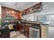 Kitchen area featuring a black granite countertop, stainless steel appliances, and wine glass rack above peninsula at 620 Peachtree Ne St # 911, Atlanta, GA 30308