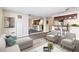Living room with bar seating, grey sofa, white chairs, hardwood style floors, and full mirror wall at 620 Peachtree Ne St # 911, Atlanta, GA 30308