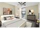 Bedroom featuring a ceiling fan, neutral walls, large windows, and artwork at 620 Peachtree Ne St # 911, Atlanta, GA 30308