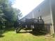 Backyard featuring staircases that lead to a deck, with an overgrowth of greenery at 8959 Stonebridge Blvd, Douglasville, GA 30134