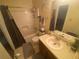 Neutral toned bathroom featuring a shower-tub combo and a vanity with a sink at 8959 Stonebridge Blvd, Douglasville, GA 30134