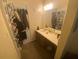 Bathroom with vanity, mirror, and storage; a practical space at 8959 Stonebridge Blvd, Douglasville, GA 30134
