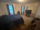 Bright bedroom with carpet, natural light, and modern dark-toned furniture at 8959 Stonebridge Blvd, Douglasville, GA 30134
