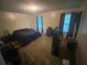 Spacious bedroom with carpet, natural light, and modern dark-toned furniture at 8959 Stonebridge Blvd, Douglasville, GA 30134