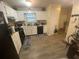Well-lit kitchen with white cabinetry, modern appliances, and durable wood-look flooring. A functional and clean space at 8959 Stonebridge Blvd, Douglasville, GA 30134