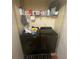 Laundry area with dark washer and dryer, a wood floor, and shelving at 8959 Stonebridge Blvd, Douglasville, GA 30134