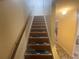 Carpeted staircase leading to the upper level with wooden handrail at 8959 Stonebridge Blvd, Douglasville, GA 30134
