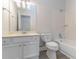 This full bathroom features a tiled shower and tub combination with a single sink vanity and ample lighting at 1333 Trailwater Chase Nw, Acworth, GA 30102