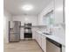 Modern kitchen with stainless steel appliances, white cabinets, and countertops, creating a clean, functional space at 1333 Trailwater Chase Nw, Acworth, GA 30102
