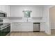 Well-lit kitchen with stainless steel appliances and white cabinets, offering ample counter space for meal preparation at 1333 Trailwater Chase Nw, Acworth, GA 30102