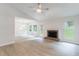 Spacious living room featuring light-colored flooring, a fireplace, and ample natural light from the windows at 1333 Trailwater Chase Nw, Acworth, GA 30102