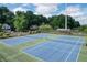 Aerial view of community amenities, featuring a playground and tennis courts at 1361 Chatley Way, Woodstock, GA 30188