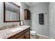 Bathroom featuring granite countertop, dark wood vanity and cabinet, and shower with decorative curtain at 1361 Chatley Way, Woodstock, GA 30188