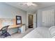 Comfortable bedroom featuring neutral tones, a ceiling fan, and a functional built-in desk space at 1361 Chatley Way, Woodstock, GA 30188