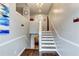 Welcoming entryway with hardwood floors, staircase, and stylish decor creating a warm ambiance at 1361 Chatley Way, Woodstock, GA 30188