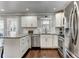Updated kitchen with stainless steel appliances, granite countertops, white cabinetry, and tile backsplash at 1361 Chatley Way, Woodstock, GA 30188