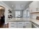 Bright kitchen with granite countertops, white cabinets, stainless steel appliances, and an adjacent dining area at 1361 Chatley Way, Woodstock, GA 30188