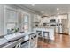 Bright kitchen with stainless steel appliances, granite countertops, and wood flooring at 1361 Chatley Way, Woodstock, GA 30188