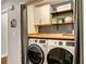 Functional laundry room with modern appliances, wood countertops, cabinets, and stylish decor at 1361 Chatley Way, Woodstock, GA 30188