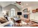 Cozy living room features a brick fireplace, vaulted ceilings, hardwood floors, and plenty of natural light at 1361 Chatley Way, Woodstock, GA 30188