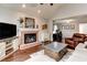 Comfortable living room with a charming brick fireplace, hardwood floors, and neutral decor at 1361 Chatley Way, Woodstock, GA 30188