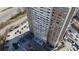 Aerial perspective of a high-rise building surrounded by roads, parking, and lush landscaping at 215 Piedmont Ne Ave # 502, Atlanta, GA 30308