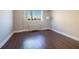 Bedroom with a large window providing city views and hardwood flooring at 215 Piedmont Ne Ave # 502, Atlanta, GA 30308