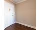 Well-lit entry foyer featuring a white door and dark wood-look floors at 215 Piedmont Ne Ave # 502, Atlanta, GA 30308