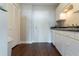 Efficient kitchen layout with white cabinets, dark countertops, and dark hardwood floors at 215 Piedmont Ne Ave # 502, Atlanta, GA 30308