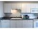 Kitchen with white cabinetry, laminate countertops, and appliances at 215 Piedmont Ne Ave # 502, Atlanta, GA 30308