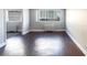 Bright living room with hardwood floors and views of the city through large windows at 215 Piedmont Ne Ave # 502, Atlanta, GA 30308