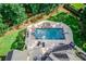 Aerial view of the backyard showing the in-ground pool and spa, with a slide, diving board, and lounge seating at 3217 Aberrone Pl, Buford, GA 30519