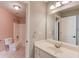 Bright bathroom featuring a toilet, tub-shower, and a single sink vanity at 3217 Aberrone Pl, Buford, GA 30519