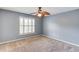 Bedroom with gray walls, carpet flooring, ceiling fan, and shuttered window at 3217 Aberrone Pl, Buford, GA 30519