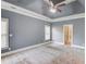 Spacious bedroom features plush carpeting, a tray ceiling, and a ceiling fan at 3217 Aberrone Pl, Buford, GA 30519