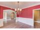 Spacious dining room featuring a stylish chandelier, and elegant archway at 3217 Aberrone Pl, Buford, GA 30519