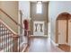 Grand foyer with soaring ceilings, hardwood floors, staircase and beautiful arched doorway at 3217 Aberrone Pl, Buford, GA 30519
