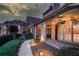 Charming front porch with decorative lighting, lush landscaping, and a welcoming entrance for guests at 3217 Aberrone Pl, Buford, GA 30519