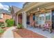 Charming front porch with rocking chairs, hanging plants, and classic brick detailing at 3217 Aberrone Pl, Buford, GA 30519