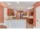 Modern kitchen featuring custom cabinets, granite countertops, and stainless steel appliances at 3217 Aberrone Pl, Buford, GA 30519
