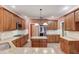 Kitchen with an island, granite countertops, stainless steel appliances, and wooden cabinetry at 3217 Aberrone Pl, Buford, GA 30519