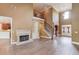 Elegant living room featuring a fireplace, high ceilings, and hardwood floors at 3217 Aberrone Pl, Buford, GA 30519