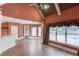 Inviting living room features hardwood floors, vaulted ceilings, and large windows with elegant curtains at 3217 Aberrone Pl, Buford, GA 30519
