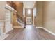 Spacious living room with a fireplace, stairs to a second floor, and a large front door at 3217 Aberrone Pl, Buford, GA 30519