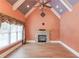 Bright living room features a stone fireplace, vaulted ceilings, and large windows at 3217 Aberrone Pl, Buford, GA 30519