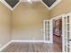 Office or study with vaulted ceilings, and double french doors leading to foyer at 3217 Aberrone Pl, Buford, GA 30519