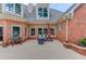 Cozy patio with outdoor seating, grill, and brick accents, perfect for relaxing and entertaining at 3217 Aberrone Pl, Buford, GA 30519